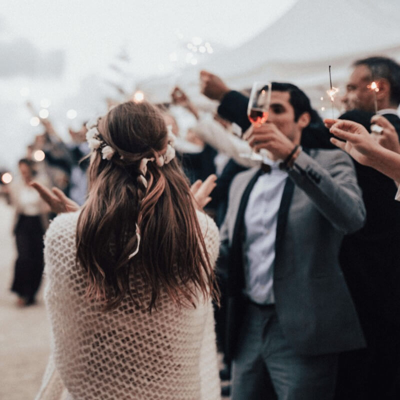 Champagne cheers at an outdoor wedding