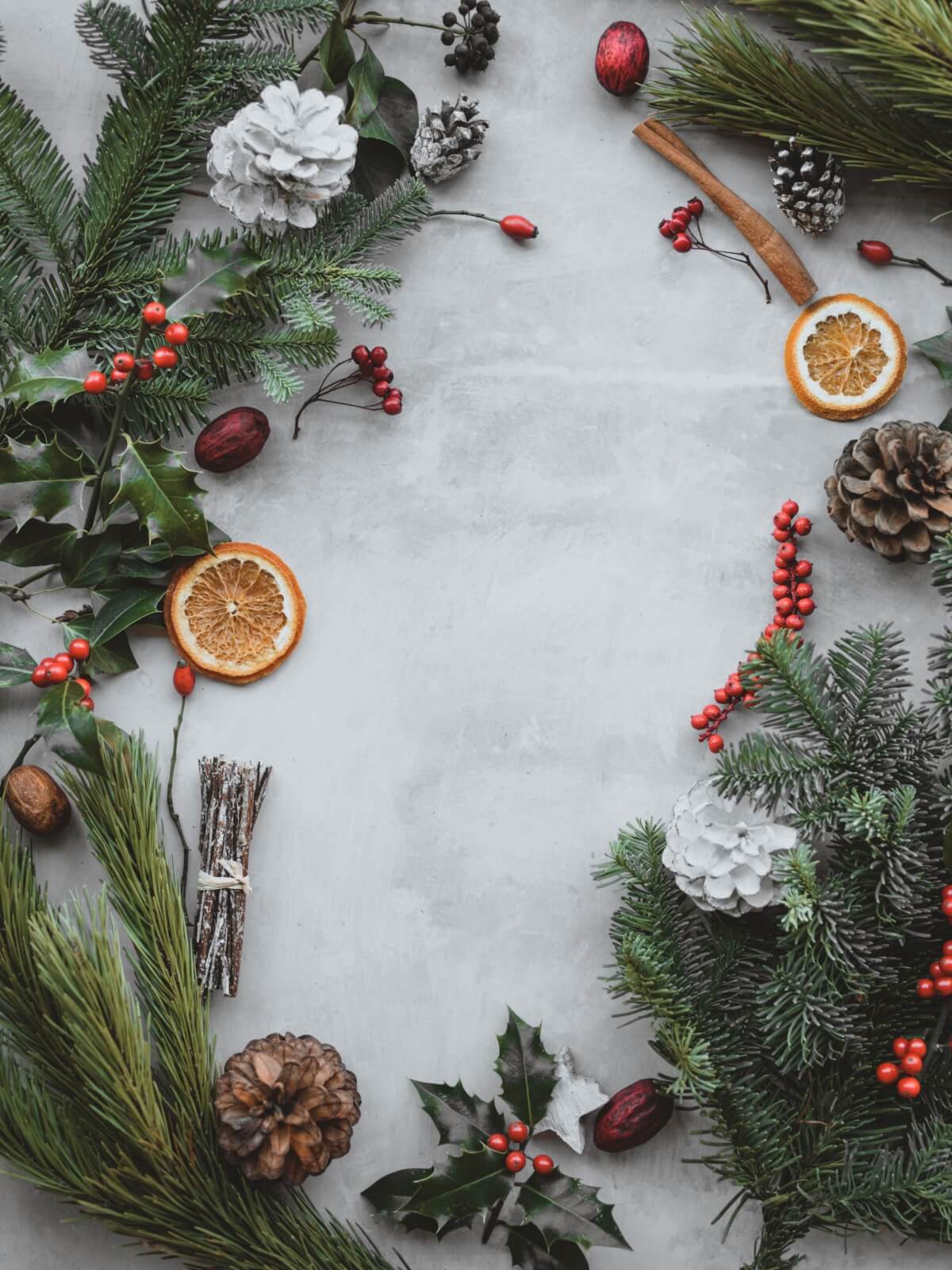 Holiday decoration items including dried oranges, pine boughs, pinecones and more.