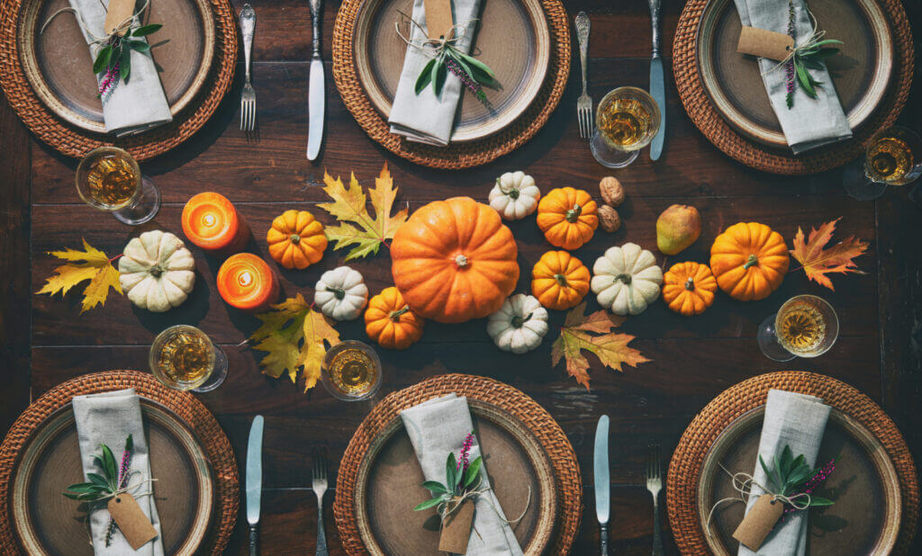 A table featuring fall-themed place settings is pictured from above.